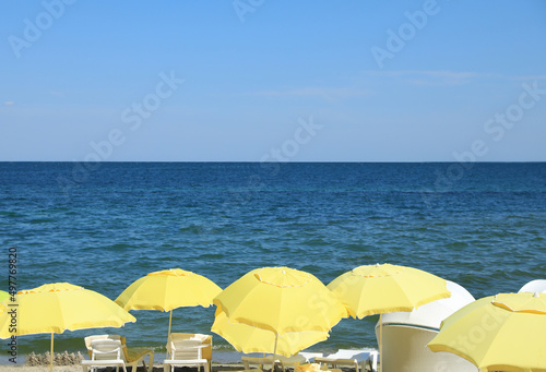Many beach umbrellas at resort on sunny day