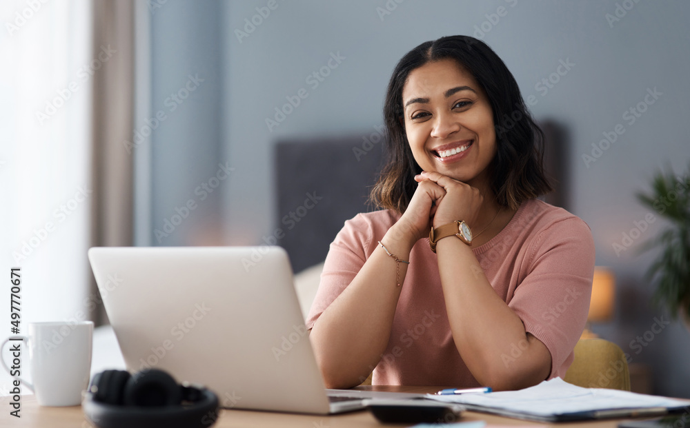 Taking on the day with a smile. Shot of a young woman working from home. Taking on the day with a smile. Shot of a young woman working from home.