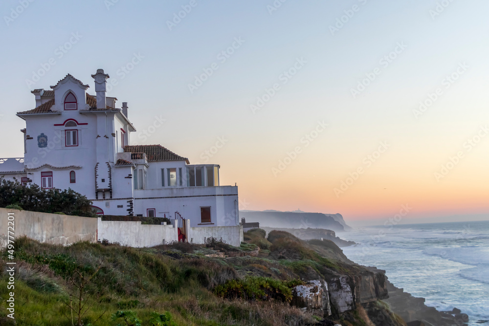 House on the Atlantic ocean coast on sunset light in Portugal, Europe