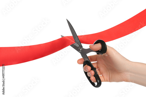 Man cutting red ribbon on white background, closeup