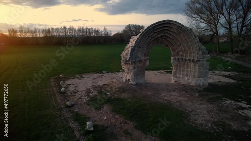 Aerial view of the ruined medieval arch of San Miguel de Mazarreros at dusk, in Olmillos de Sasamon. Burgos, Spain. High quality 4k footage photo