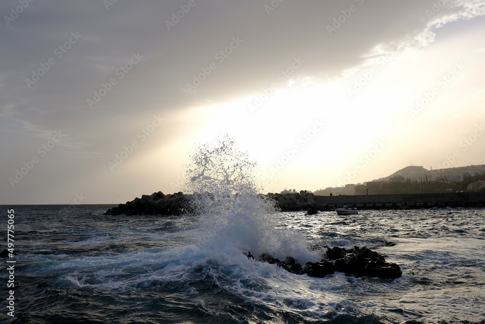 Madeira, Portugal - scenery of coast with huge waves around Funchal in sunset light