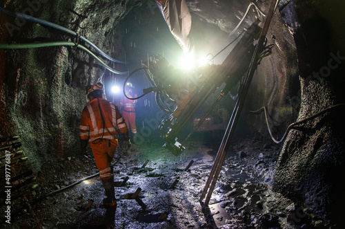 Mining operator on mining machine, underground mine mesh photo
