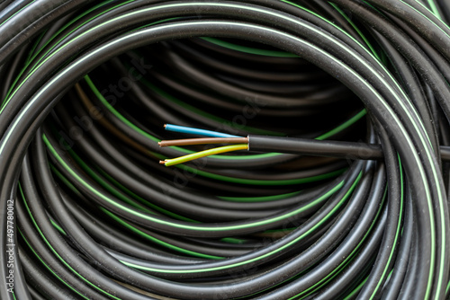 Electric cable, wire with green, yellow, brown and blue smaller wires, an electrical installation material for electricians, industry concept