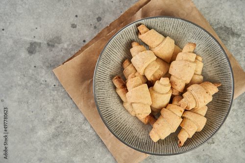 Russian slavic traditional pastry called roguelikes. Cakes bagels. Crispy croissants. Food on grey background, Copy space