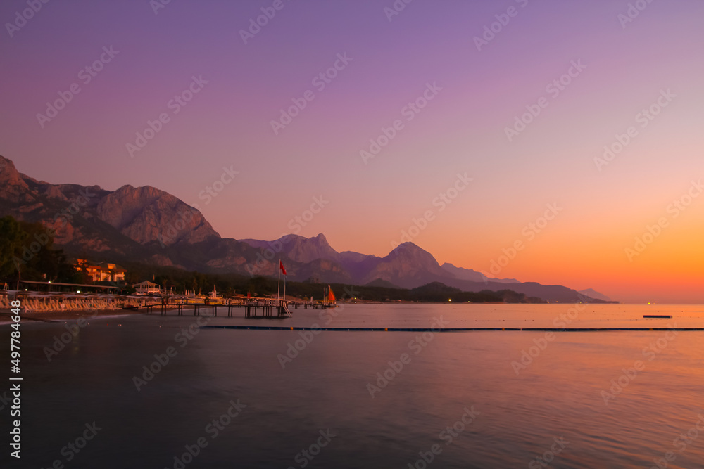 Beautiful sunset near the Mediterranean Sea in Turkey. View of hotels and mountains.