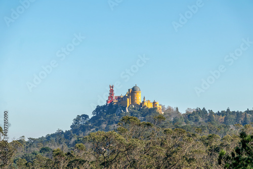 The Pena Palace on the top of a green hill in the Sintra Mountains in a clear day with blue sky  Portugal  Europe