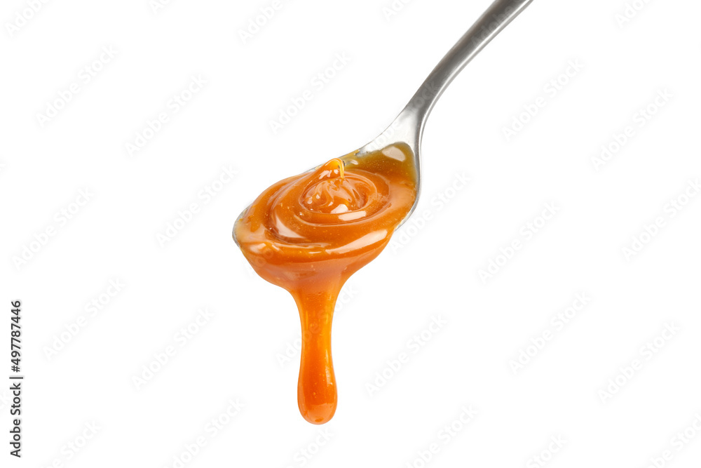 Liquid caramel on spoon. Caramel drips from the spoon. Pouring sweet caramel sauce. Texture, Close up. Liquid caramel on spoon. Caramel drips from the spoon. Pouring sweet caramel sauce. Texture, Close up.