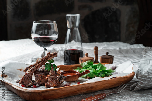 Grilled lamb loin on a wooden plate with wine