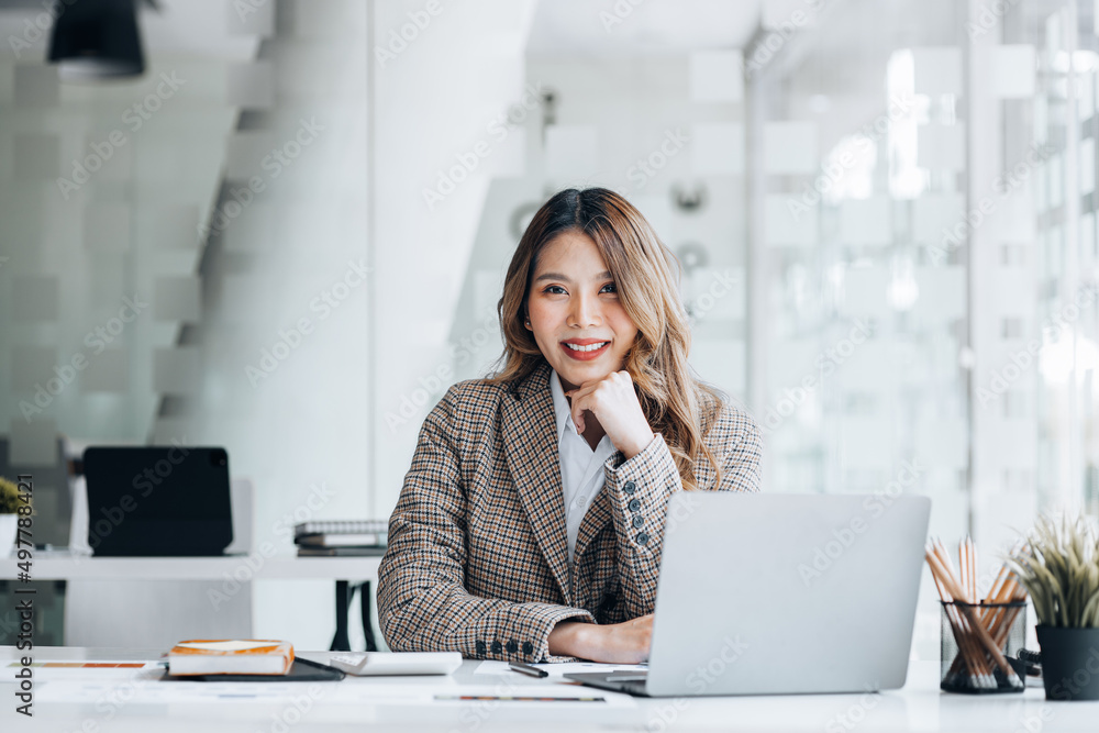 Portrait of a young beautiful Asian woman in a office room, concept image of Asian business woman, modern female executive, startup business woman, business leader woman.