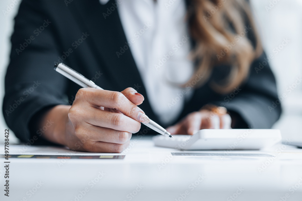 Business woman holding financial documents, she owns a startup company, she sits checking the company's financial summary prepared by the finance department. Management concept of startup company. Business woman holding financial documents, she owns a startup company, she sits checking the company's financial summary prepared by the finance department. Management concept of startup company.