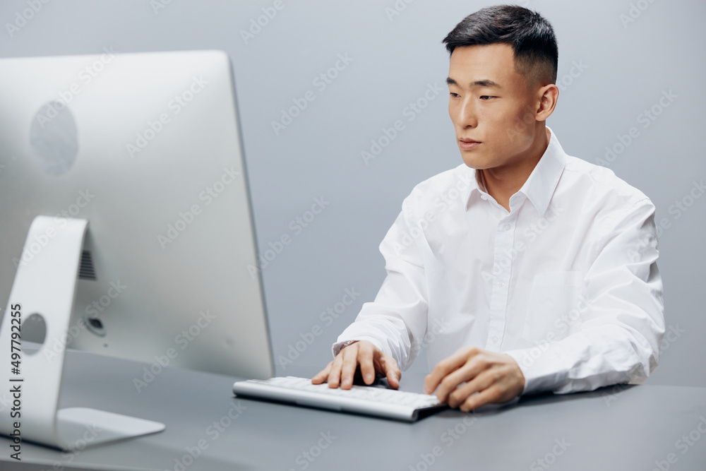 man in a white shirt works at a computer in the office Lifestyle work man in a white shirt works at a computer in the office Lifestyle work