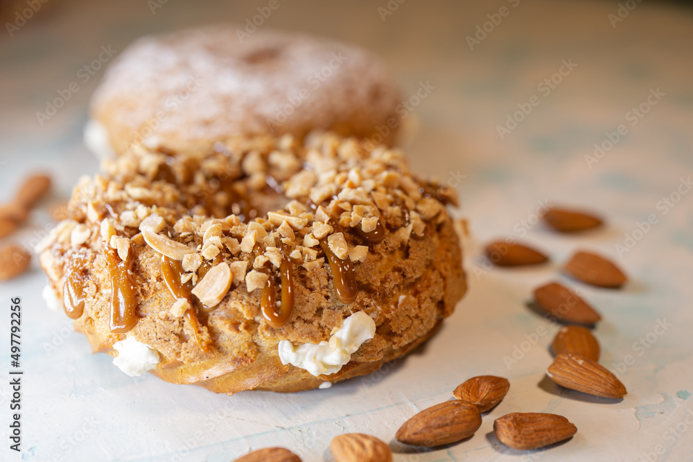 A piece of delicious handmade donut with nuts close-up A piece of delicious handmade donut with nuts close-up