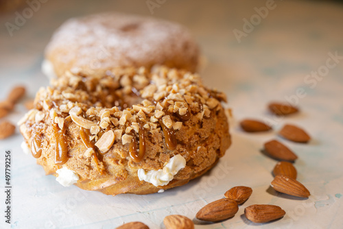 A piece of delicious handmade donut with nuts close-up