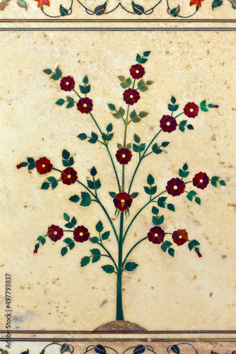 фотографія Beautiful inlaid decorative flowering tree created with semi precious stones on white marble panel on column in the Hall of Private Audience (Diwan I Khas) of Red Fort