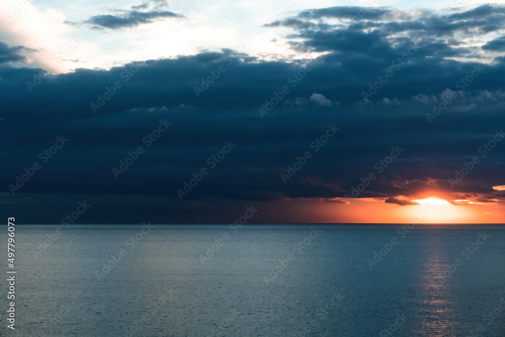 Sunrise over the sea with stormy skies