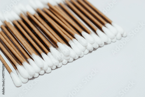 Eco-friendly bamboo cosmetic cotton buds on a light background.