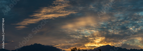Panoramic image with colorful clouds during sunrise or at dawn