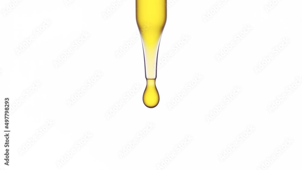 Macro shot of yellow drop dripping from chemical dropper on white background | Abstract body care serum ingredients formulating concept Macro shot of yellow drop dripping from chemical dropper on white background | Abstract body care serum ingredients formulating concept