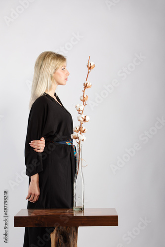 Young beautiful lady in a black trendy and fashionable kimono.