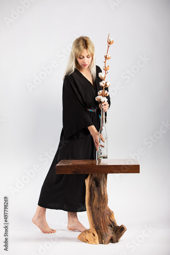 Young beautiful lady in a black trendy and fashionable kimono.