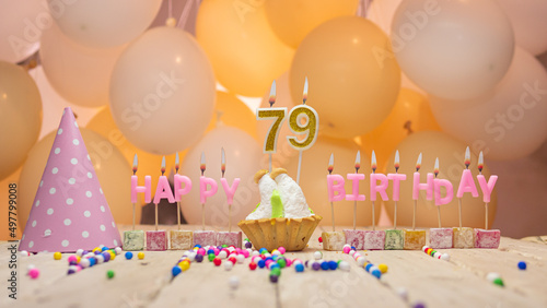Beautiful background happy birthday number 79 with burning candles, birthday candles pink letters for seventy nine years. Festive background with balloons. photo