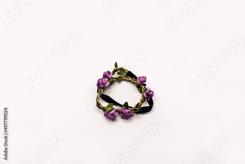 Hair accessory with mauve flowers isolated on white.