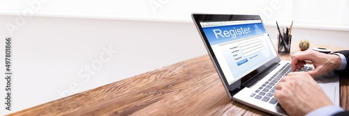 Man Filing Online Registration Form On Laptop