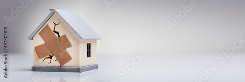 Fotografie House Model With Crossed Band Aid