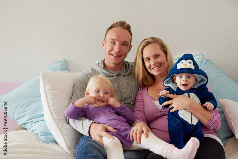 Kids bring so much warmth into a family. Portrait of a happy family spending quality time together at home.