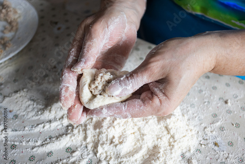  Woman cooking pies with meat at home. Cooking and baking at home. © Vitalina