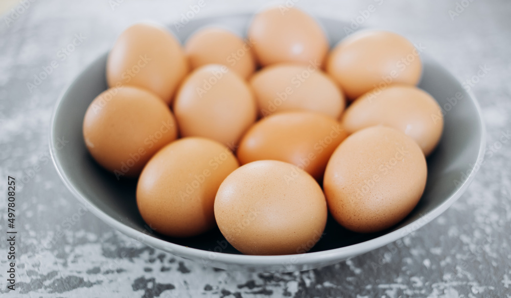 White eggs on a grey plate and a blue background White eggs on a grey plate and a blue background