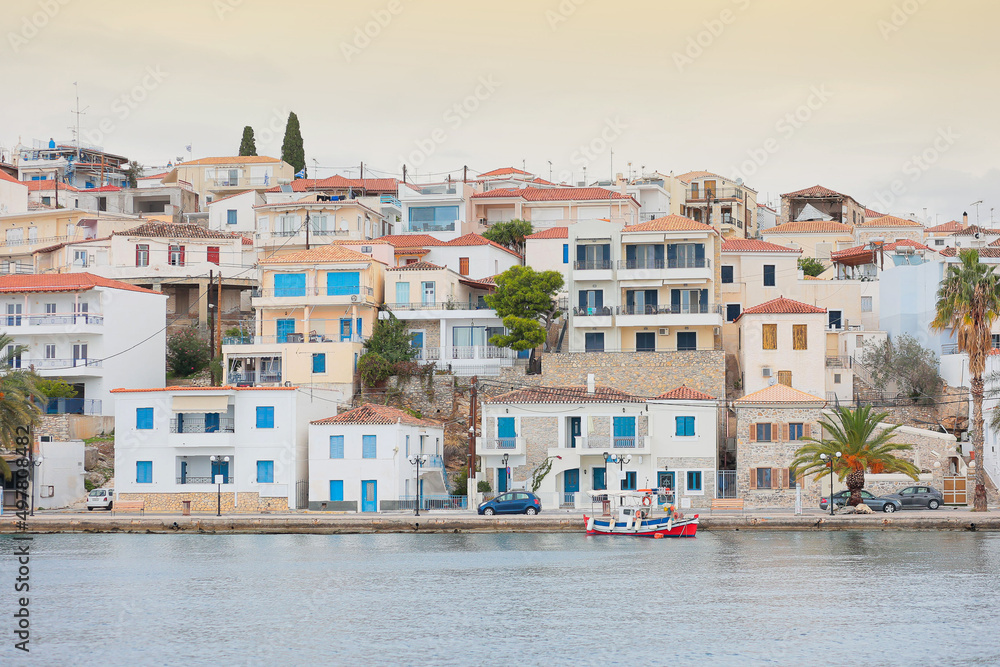 view of the pier and houses from the sea in greece.