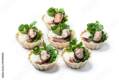 Mini tarts filled with marinated squid and mussels isolated on white