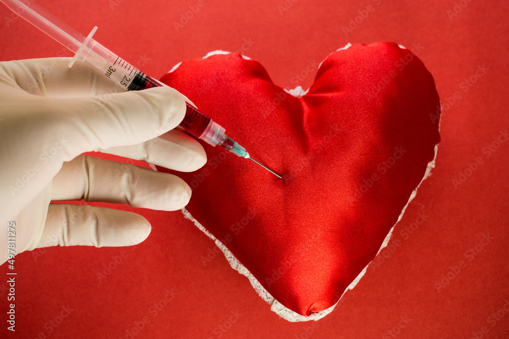 Blood donation topic, doctor hand drawing blood with a syringe from a