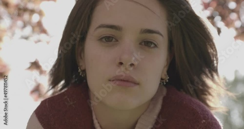 young confident woman approaches the camera bending over cracking a smile