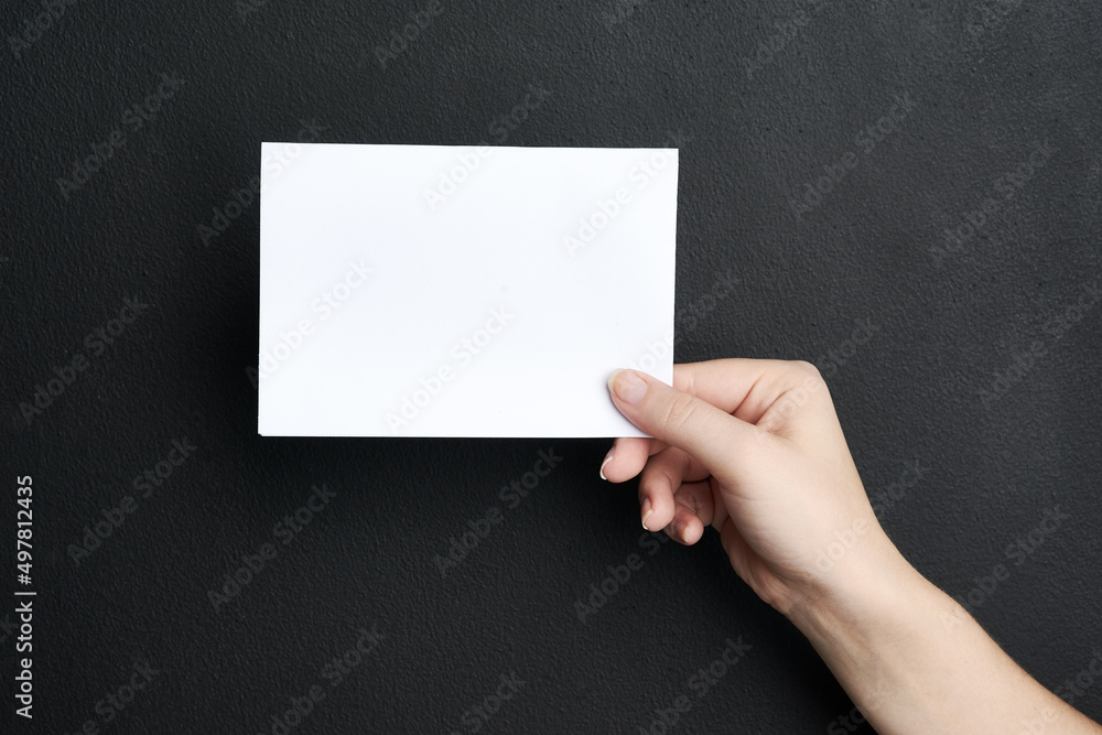 Insert your message here. Shot of a woman holding a blank board against a dark background. Insert your message here. Shot of a woman holding a blank board against a dark background.