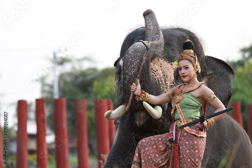 2022 Songkran goddness legendary faith name Kirini Thewi  holding weapons, gun nuts beside with elephant  , Thailand new year day call Songkran festival photo