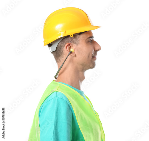 Male builder with earplugs on white background photo