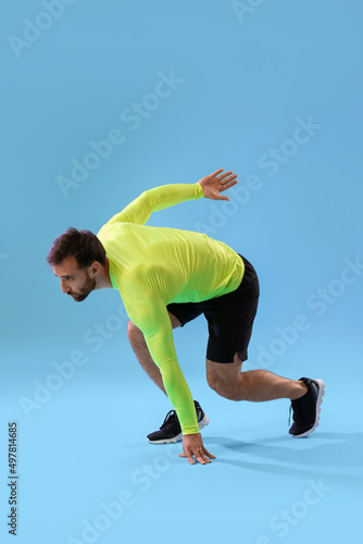 Sporty male runner on color...