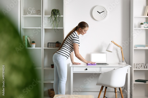 Young woman cleaning her house