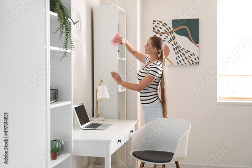 Young woman cleaning her house