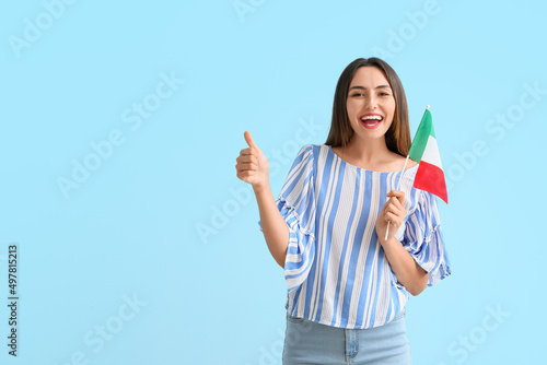Young woman with Italian flag showing thumb-up on color background