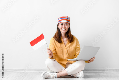Young Asian woman with flag...