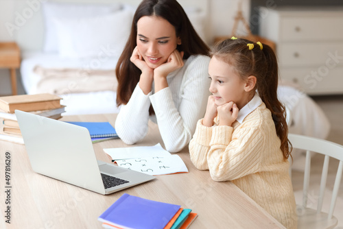 Cute girl studying with tut...