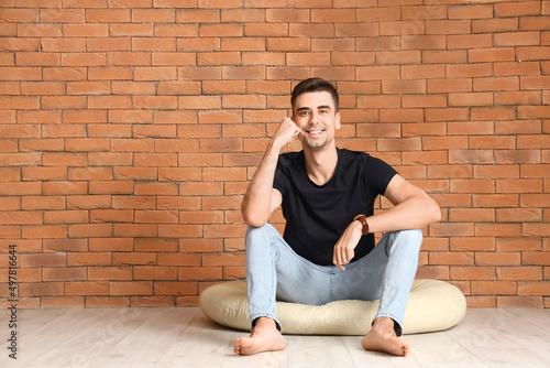 Young barefooted man sittin...