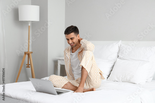 Young barefooted man using ...