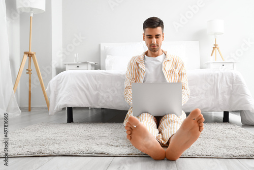 Young barefooted man using ...