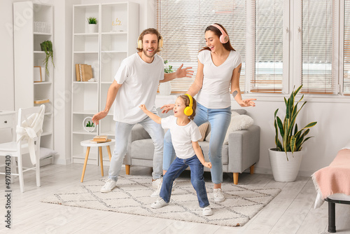 Happy young family listenin...