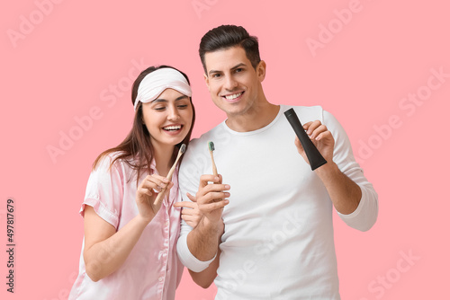 Happy couple holding bamboo...